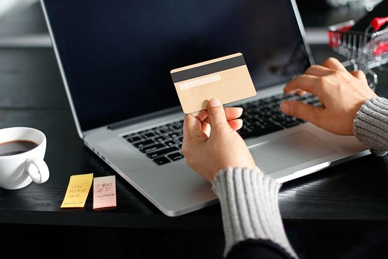 A person using a credit card to make an online payment.