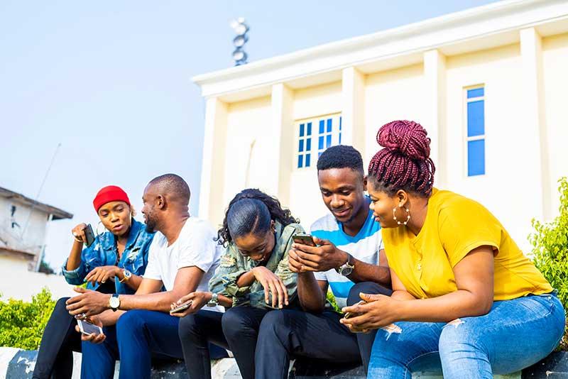 Group of African friends on cell phones.