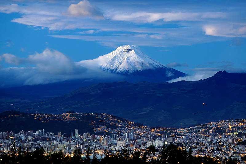 Lever de soleil dans la ville de Quito et le volcan Cotopaxi.