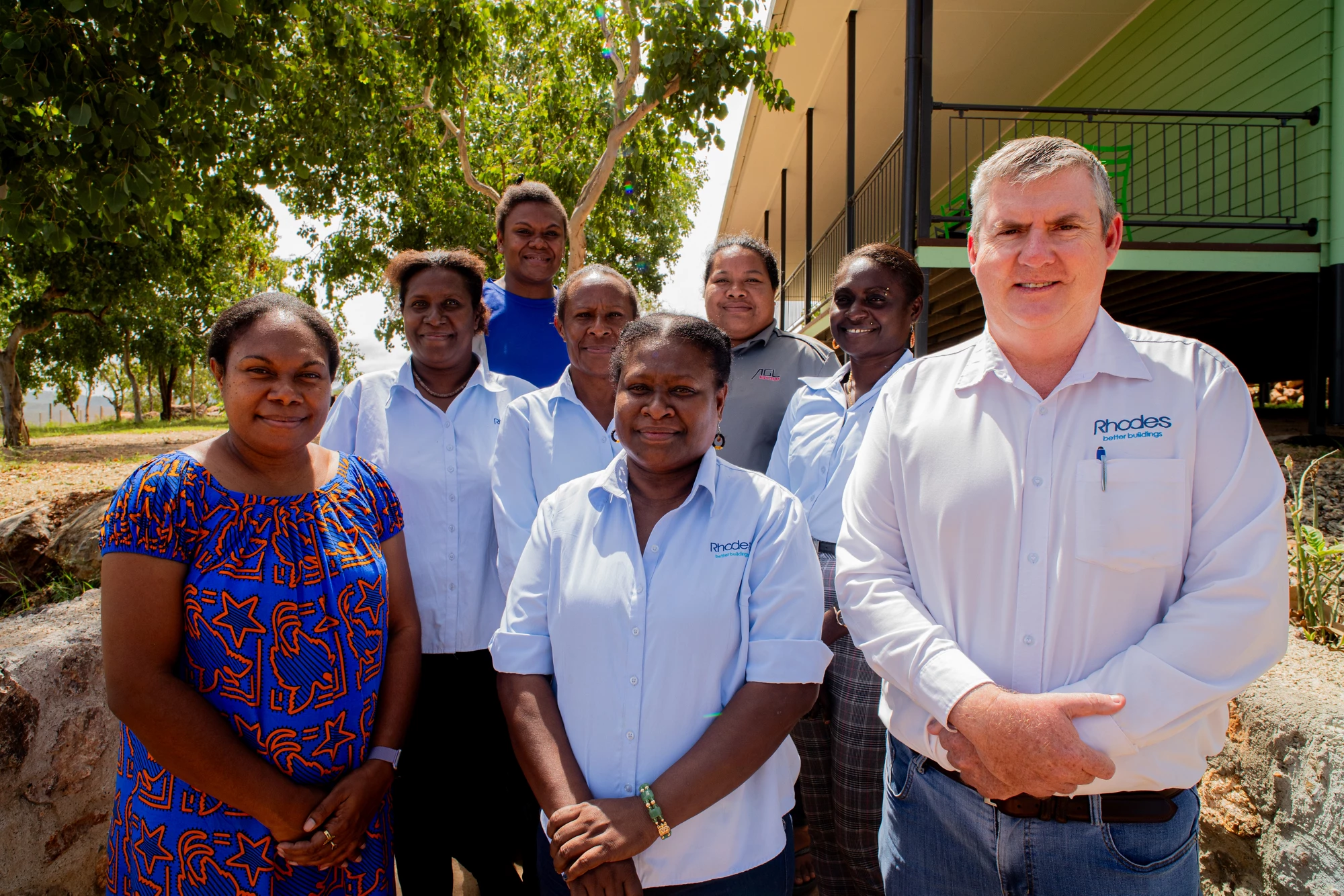 8 people from the human resources team at Rhodes PNG Ltd pose for the camera at Tuhava.